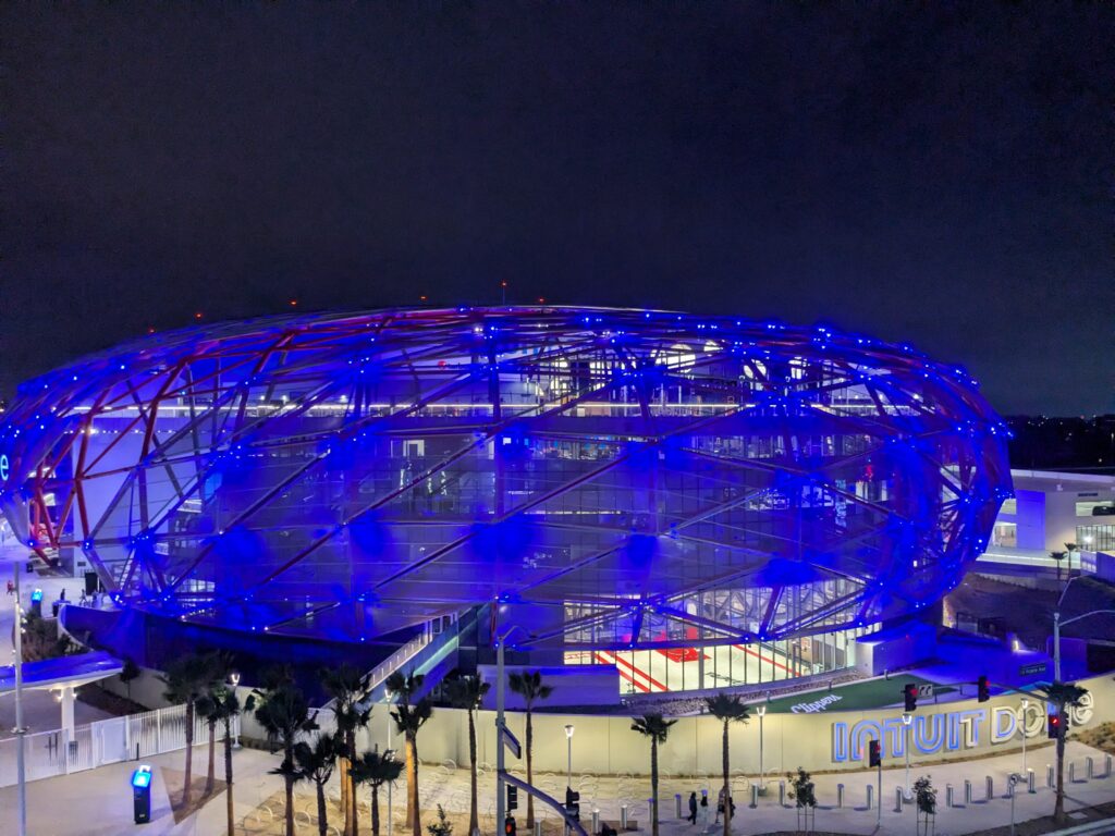 Intuit Dome in Inglewood lit in blue at night